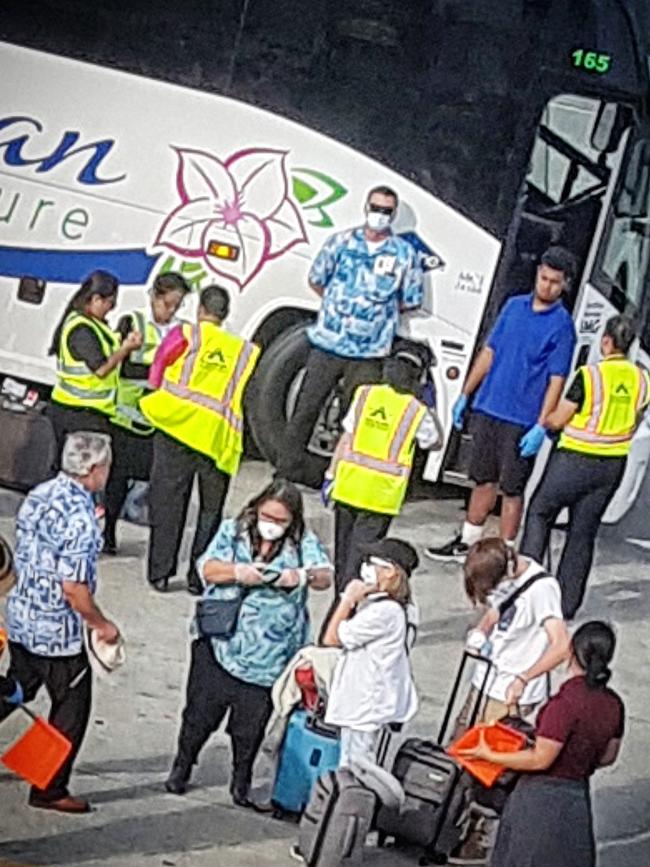 Norwegian Jewel passengers greeted by Hawaiian officials before boarding their flight back to Australia. Picture: Tom Huntley