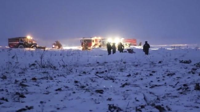 Emergency workers at the scene of the AN-148 plane crash in Stepanovskoye village. Picture: Russian Ministry for Emergency Situations photo via AP.