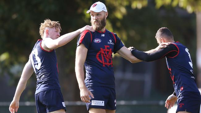 Clayton Oliver, left, with Max Gawn and Christian Salem, is becoming very affordable in SuperCoach.