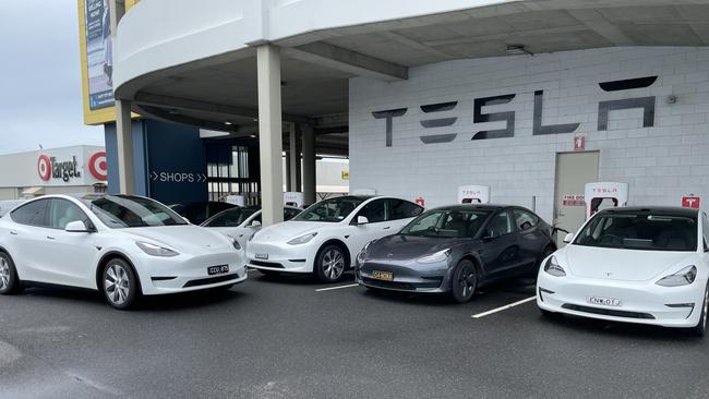 On the second last day of 2022 it was a waiting game at the Tesla charging station at north Coffs Harbour. Picture: Chris Knight