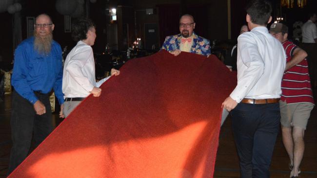 Frantic efforts are made to save the red carpet from a severe hailstorm.