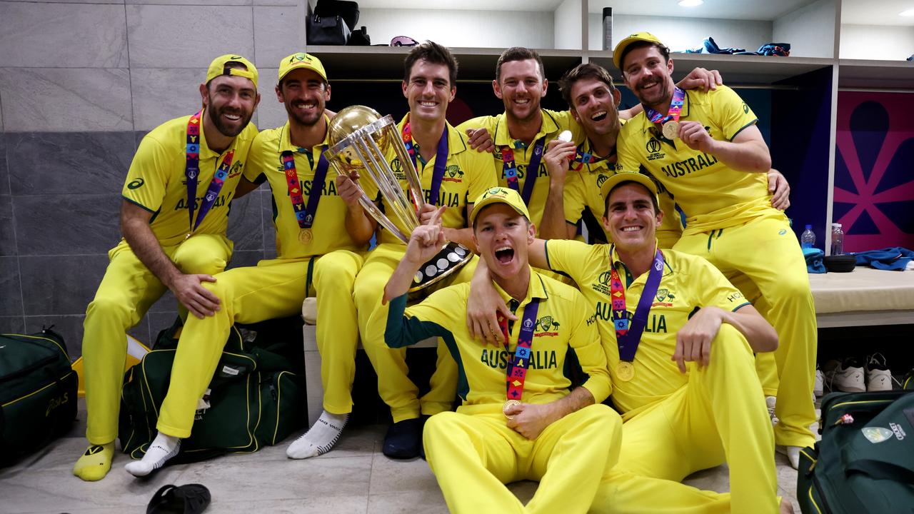 AHMEDABAD, INDIA - NOVEMBER 19: Sean Abbott, Adam Zampa, Pat Cummins, Travis Head, Glenn Maxwell, Mitchell Starc, Josh Hazlewood and Mitch Marsh of Australia pose with the ICC Men's Cricket World Cup following the ICC Men's Cricket World Cup India 2023 Final between India and Australia at Narendra Modi Stadium on November 19, 2023 in Ahmedabad, India. (Photo by Robert Cianflone/Getty Images)