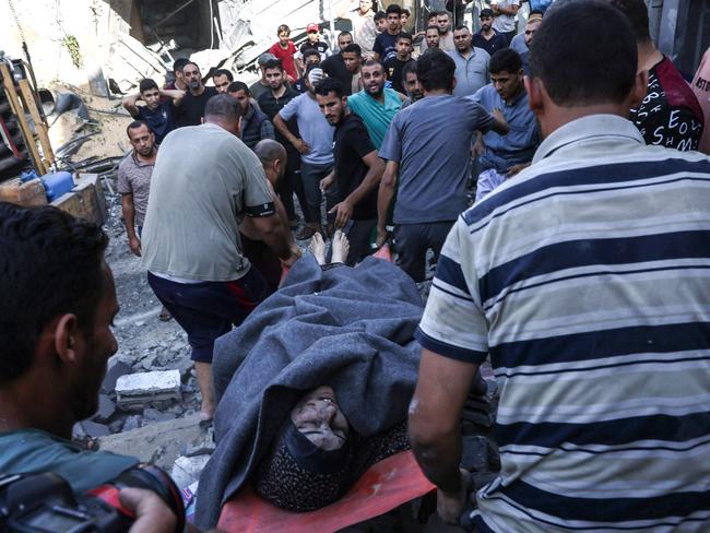 A Palestinian woman is rescued from a collapsed home following an Israeli air strike in Rafah, in the southern Gaza Strip. Picture: AFP