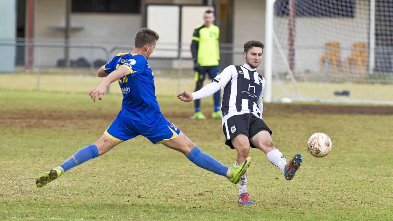 CLOSE MATCH: USQ's Jacob Stoner (left) attempts to block a kick from Willowburn's Nik Lawson during their Toowoomba Football League Premier Men's semi-final at Commonwealth Oval. USQ won the match 2-1. Picture: Kevin Farmer