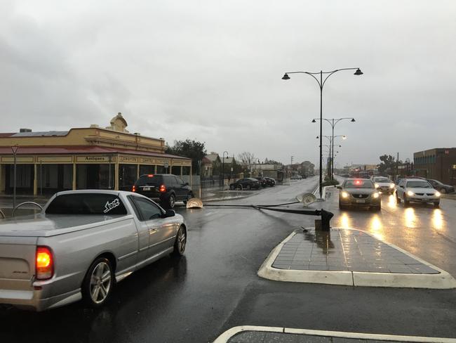 The storm brought down this light pole down on Semaphore Road. Photo: Dean Martin