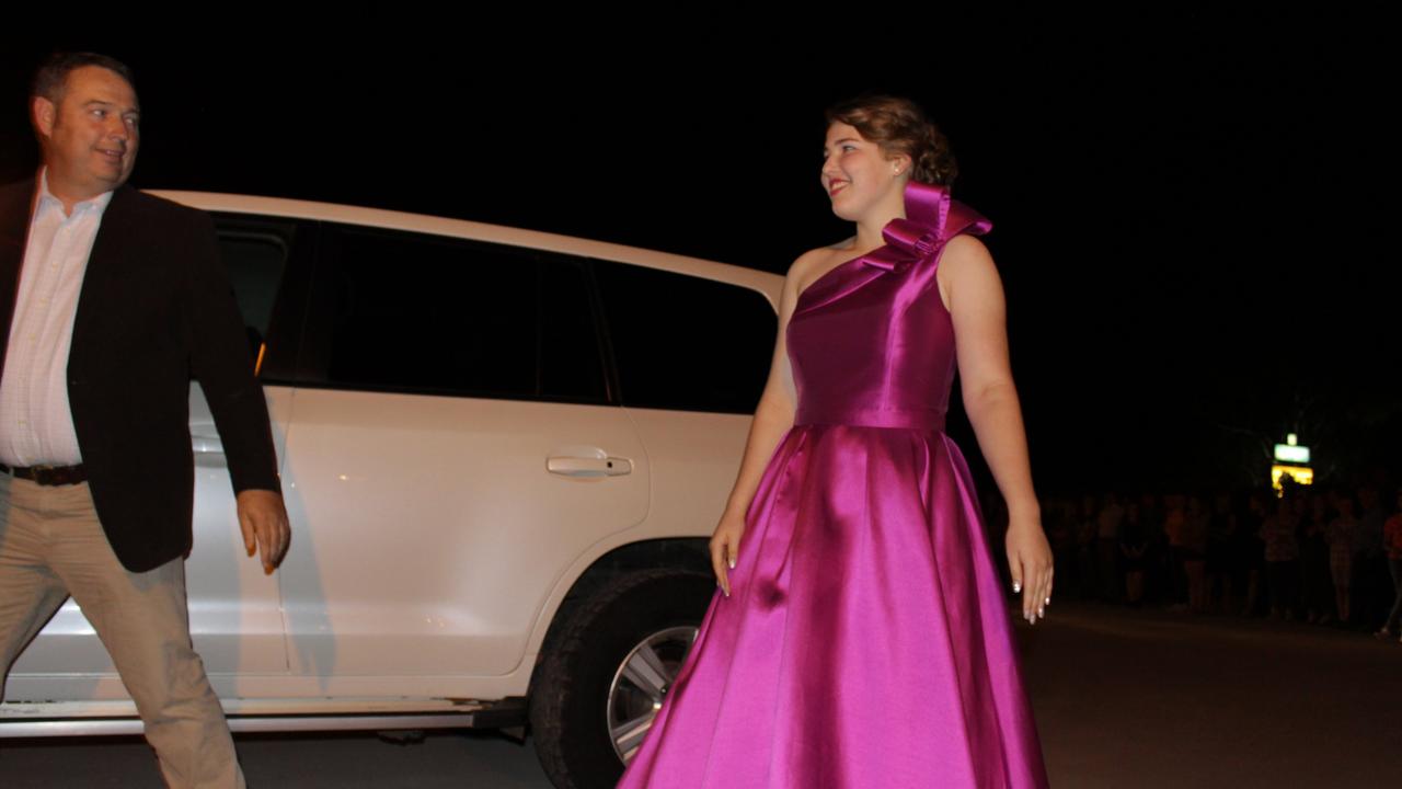 Janice Golder looks back at her father Tyson on the red carpet at the St John's Formal in Roma.