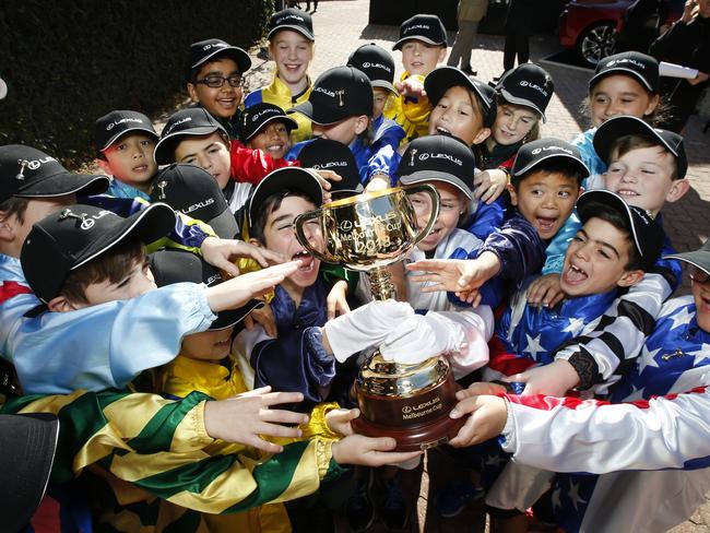 St Margaret's Primary School students trying to touch the Melbourne Cup. Picture: David Caird