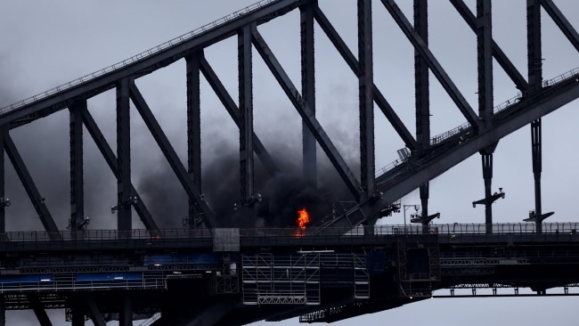 The crash resulted in a Toyota Kluger bursting into flames, with thick smoke seen billowing from the Harbour Bridge. Picture: Brendon Thorne/Getty Images