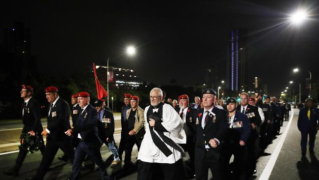 Dawn Service at Southport. an unauthorised march makes its way down the Gold Coast Highway. Picture Glenn Hampson