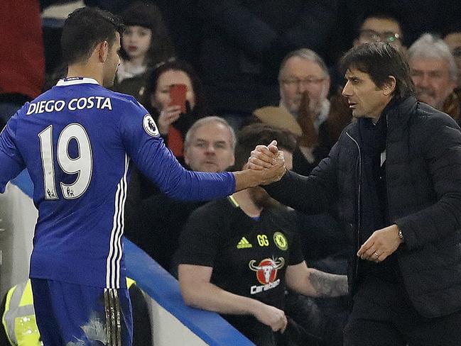 Chelsea's Diego Costa, left, shakes hands with Chelsea's team manager Antonio Conte.