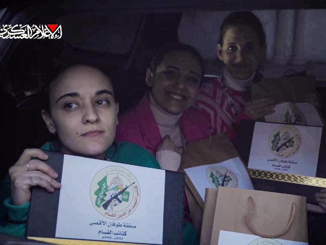 The Israeli hostages pose with documents bearing the logo of the Ezzedine al-Qassam Brigades, Hamas's armed wing, certifying the ceasefire and hostage-prisoner exchange deal. Picture: Hamas Media Office/AFP