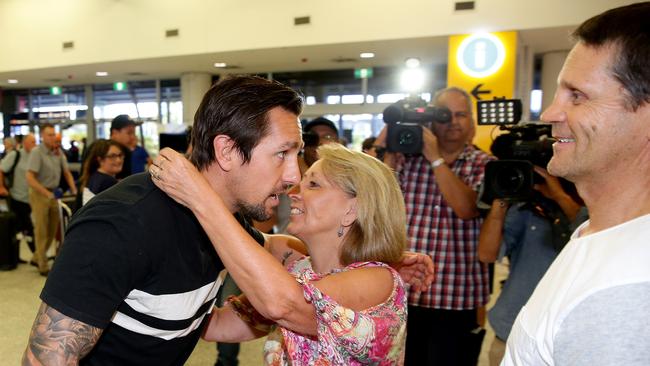 Mitchell Pearce greeted by his parents Terri and Wayne. Picture: Gregg Porteous