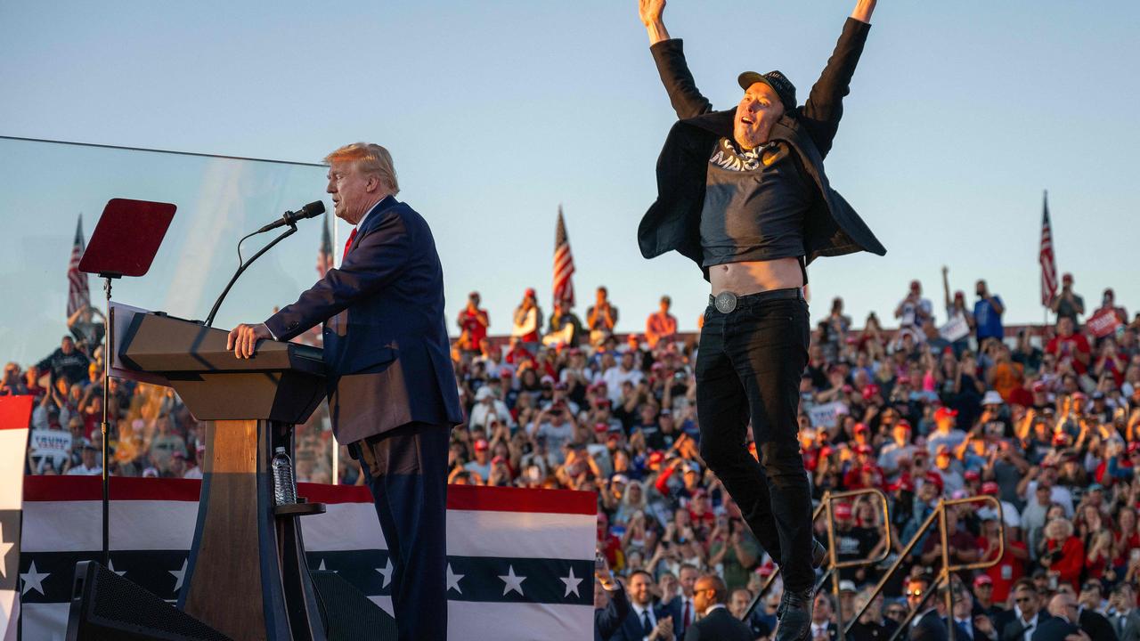 Tesla CEO Elon Musk jumps on stage as he joins former US President and Republican presidential candidate Donald Trump during a campaign rally. Photo: Jim WATSON / AFP