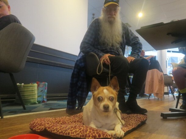 Dennis Scott and his dog at Port Panthers evacuation centre. Picture: Daniel Mills