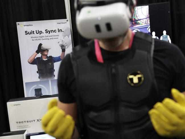 A man tries out the Haptic Suit by bHaptics during a press event at CES 2023 at the Mandalay Bay Convention Center on January 03, 2023 in Las Vegas, Nevada. CES, the world's largest annual consumer technology trade show, runs from January 5-8 and features about 3,100 exhibitors showing off their latest products and services to more than 100,000 attendees. Alex Wong/Getty Images/AFP (Photo by ALEX WONG / GETTY IMAGES NORTH AMERICA / Getty Images via AFP)