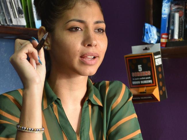 In this Feb. 5, 2015 photo, Ravn Rae sits behind the counter of her smoking supplies store, Mez, located in a hotel complex in Kingston, Jamaica. Some of Rae's acquaintances suggested she would have difficulty succeeding in a niche trade dominated by men, but about a year-and-a-half after launching her store, her company is growing and she’s proving doubters wrong in a Caribbean country where women have made such big advances in professions once dominated by men that a new U.N. study says it has the world’s highest proportion of female bosses. (AP Photo/David McFadden)