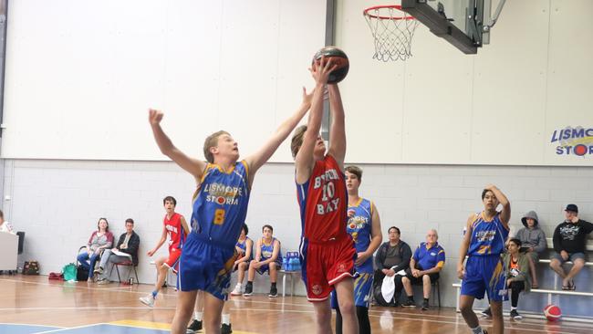 Byron Bay's Xander Barber-McLeod scoring off a rebound against Lismore in the North Coast Shield basketball competition.