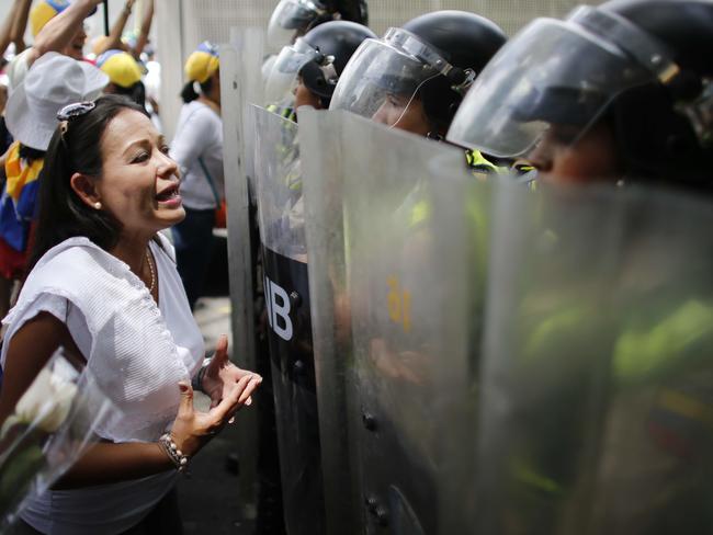 Thousands of women wearing white and carrying flowers marched on Saturday to pay tribute to those who were killed in weeks of demonstrations calling on President Nicolas Maduro to step down. Picture: Ariana Cubillos/AP