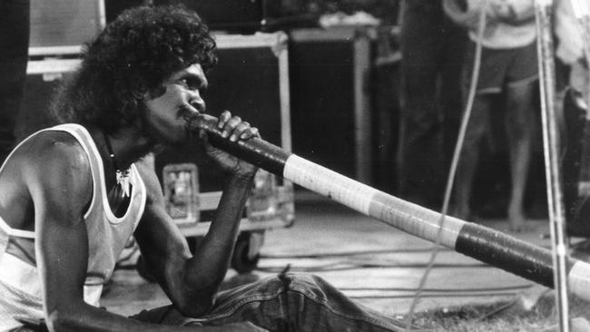 George plays the didgeridoo while touring with Midnight Oil on the Blackfella/Whitefella tour in 1986.