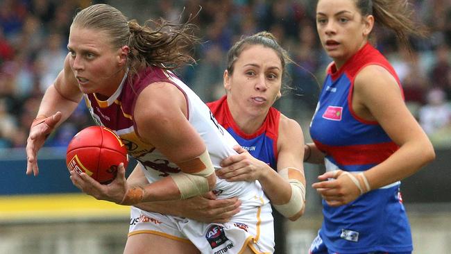 Kate Lutkins is tackled by Angelica Gogos during the AFLW Grand Final.