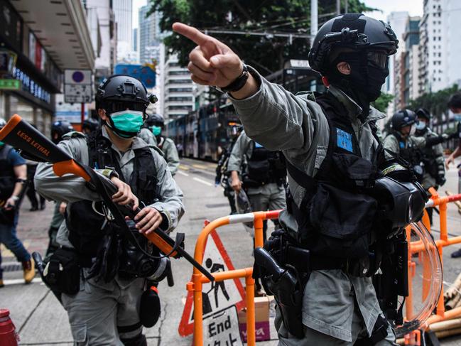 Riot police clear up debris left by protesters attending a pro-democracy rally against a proposed new security law in Hong Kong. Picture: AFP