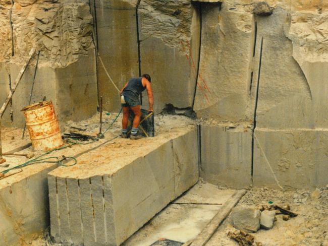 Workman cutting stone blocks at Wondabyne Quarry in 1985.