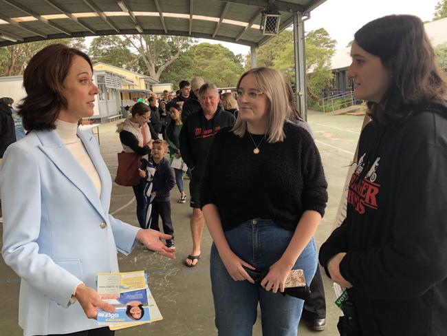 Mackellar independent candidate Sophie Scamps with some last day federal election campaigning at Narraweena Public School on Saturday. She is speaking with voting sisters Bronte and Neve Denmead, from Narraweena. Picture: Jim O'Rourke