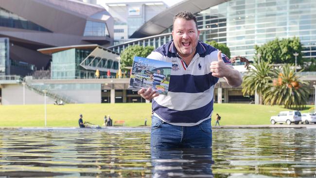 Andrew 'Cosi' Costello with his new book at Pinky Flat on the Torrens, October 29, 2022. Picture: Brenton Edwards