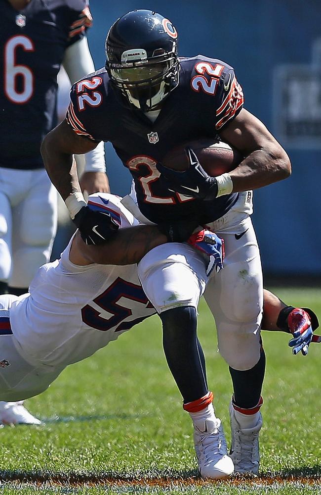 Matt Forte #22 of the Chicago Bears tries to run past Ty Powell #57 of the Buffalo Bills.