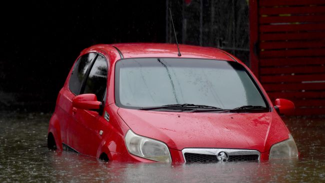 A car is partially submerged on Saturday following heavy rain in Brisbane. Picture: John Gass