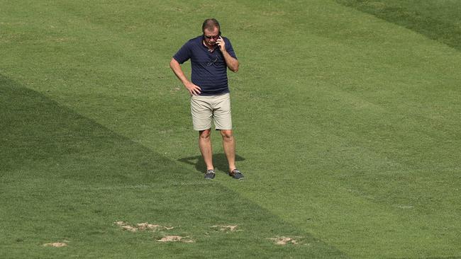 Staff are scrambling to have the pitch ready in time. Picture by Brett Costello. 