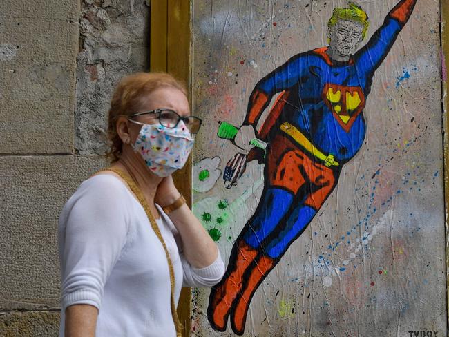 Pro-Trump artwork by street artist TVBoy in Barcelona, showing the US President as Superman flying through a cloud of COVID-19. Picture: AFP <span id="U70287294646943H" style="font-family:Merriweather Georgia 'Times New Roman' Times serif;font-size:11pt;"> </span>