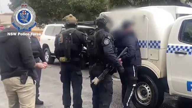 A man is arrested by heavily-armed police on Everton St, Hamilton on Tuesday following an investigation into a series of alleged armed robberies across the Hunter. Picture: NSW Police.