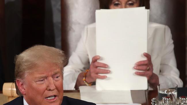 Donald Trump delivers his State of the Union address while House Speaker Nancy Pelosi prepares to tear it up. Picture: AFP.