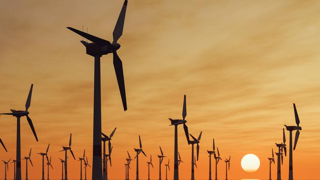 Offshore wind turbine farm at sunset.