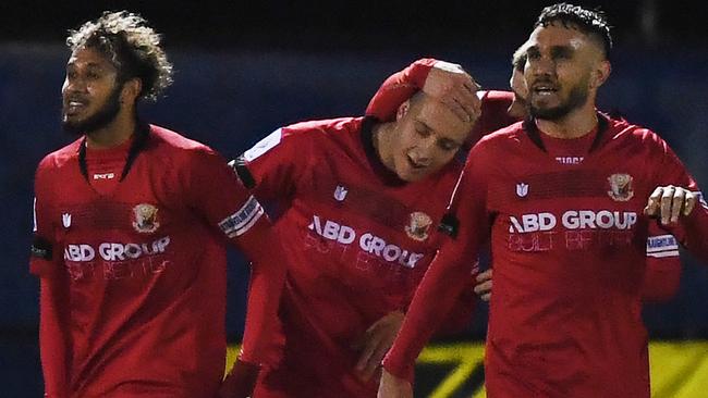 Marko Delic (centre) celebrates his second goal of the game.