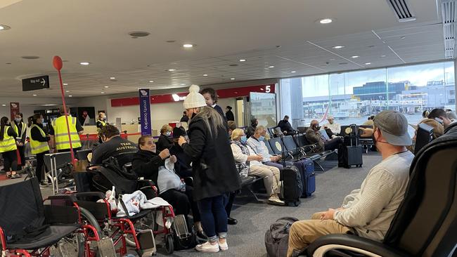 Passengers at a Virgin Australia domestic gate at Melbourne Airport arriving into Victoria and having their border passes checked.