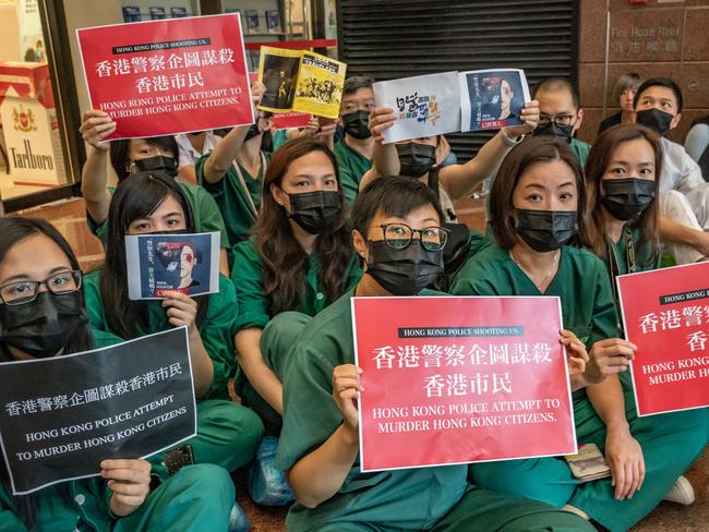 Members of the medical profession gather to protest against Hong Kong police brutality at Queen Elizabeth Hospital.