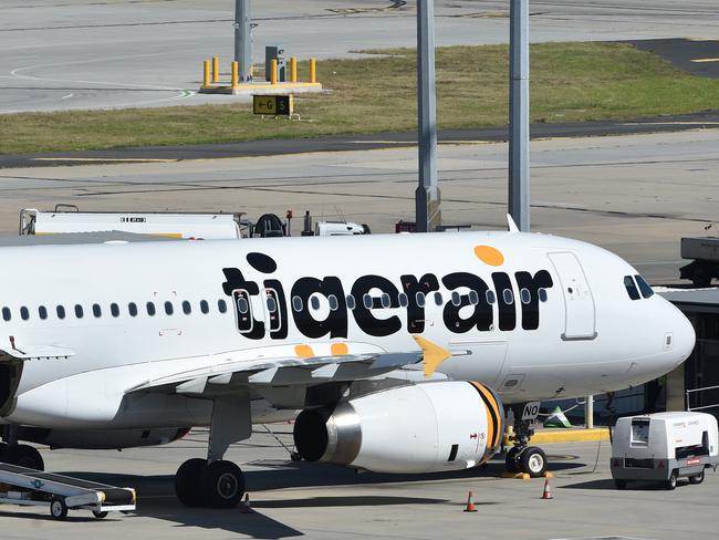 Emergency service crews are seen alongside Tiger Airways flight 511 at Melbourne Airport in Melbourne, Tuesday, March 15, 2016. Cabin crew are being treated after a Tigerair plane, travelling from Brisbane, landed safely at Melbourne Airport following reports of an odour in the cabin. (AAP Image/Julian Smith) NO ARCHIVING