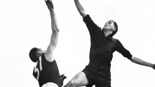 Bert Clay (left) loses a ruck contest to Jack Jones (Essendon) in 1951. Picture: Herald Sun