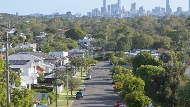 Brisbane - Nov 18 2023:Residential houses street against Brisbane City skyline.Home prices across Australia have hit new highs, with the median value of a home in a capital city shooting to $832,000. housing suburbs generic