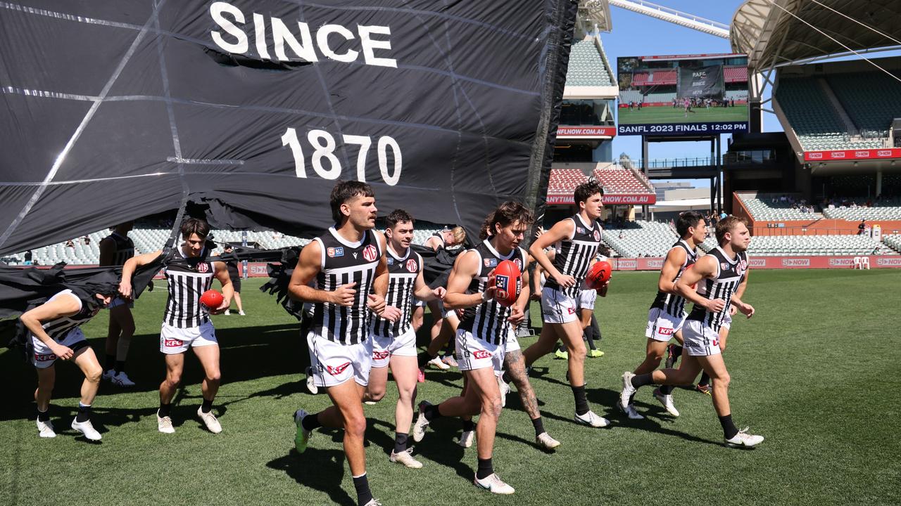 Magpies players run onto the field during the elimination final SANFL match between Central District and Port Adelaide at Adelaide Oval in Adelaide, Sunday, September 3, 2023. (SANFL Image/David Mariuz)