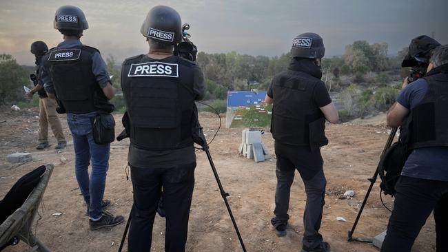 Journalists report from a vantage point overlooking northern Gaza in Sderot, Israel.