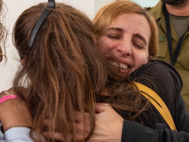 Danielle Aloni embracing family members upon her arrival at a hospital in Israel, following her release by Hamas in Gaza. Picture: Israel Army / AFP