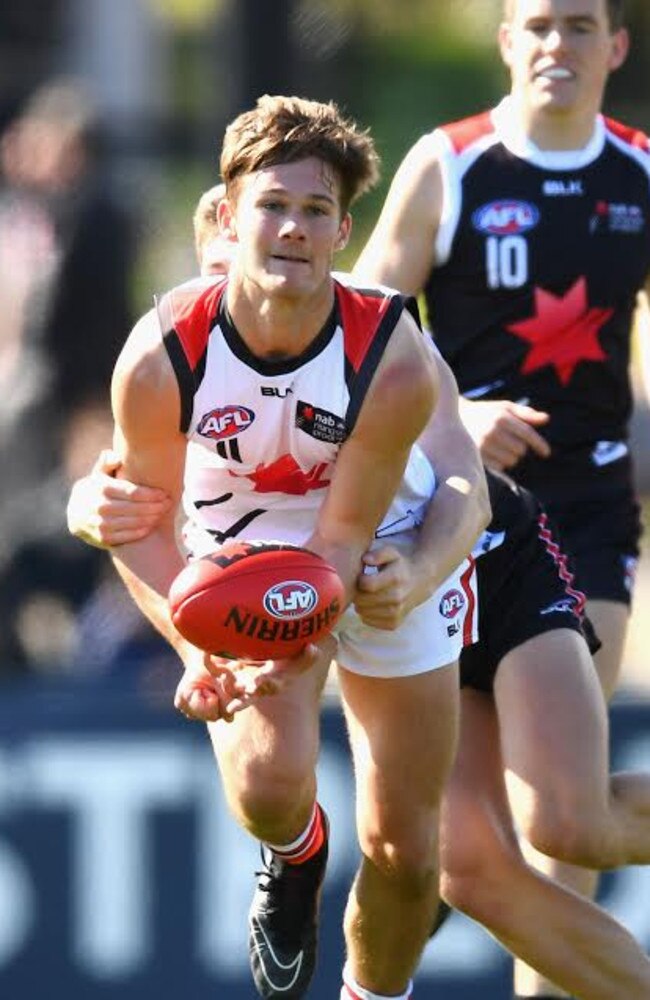 Hard at it . Jonty Scharenberg handballs for the Michael O'Loughlin under-18s during the NAB All Stars  match in September. Picture: Quinn Rooney (Getty Images)