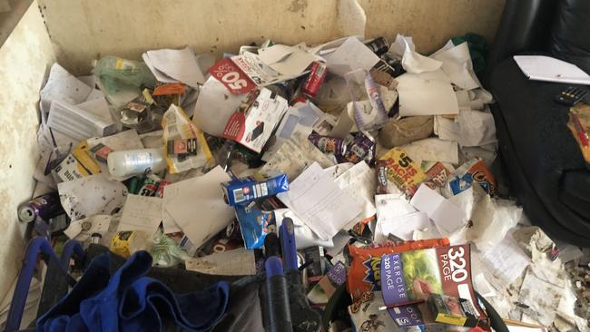 Rubbish next to a couch in a Gold Coast unit’s living room. Photo: BIO Busters