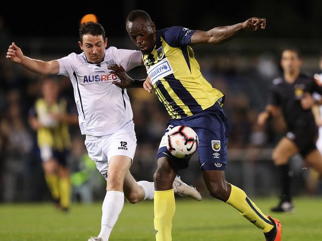 Usain Bolt holds off a defender before scoring his first goal on Friday night. Picture: Brett Costello