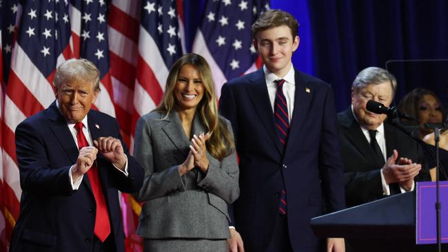 Donald, Melania and Barron Trump celebrate.