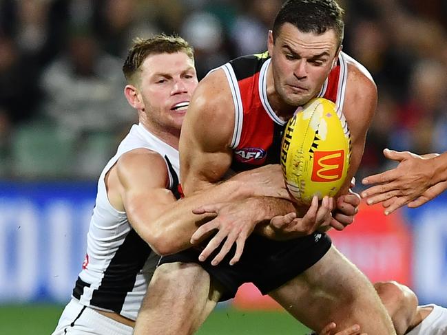 ADELAIDE, AUSTRALIA - APRIL 16: Brad Crouch of the Saints tackled by Taylor Adams  and Brayden Maynard of the Magpies during the round five AFL match between St Kilda Saints and Collingwood Magpies at Adelaide Oval, on April 16, 2023, in Adelaide, Australia. (Photo by Mark Brake/Getty Images)