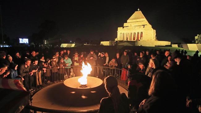 Thousands gather around the Eternal Flame at Melbourne’s Shrine of Remembrance for the Anzac Day dawn service. Picture: Aaron Francis